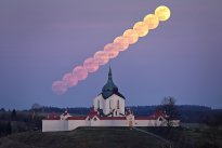 Pink full moon abovce Green hill